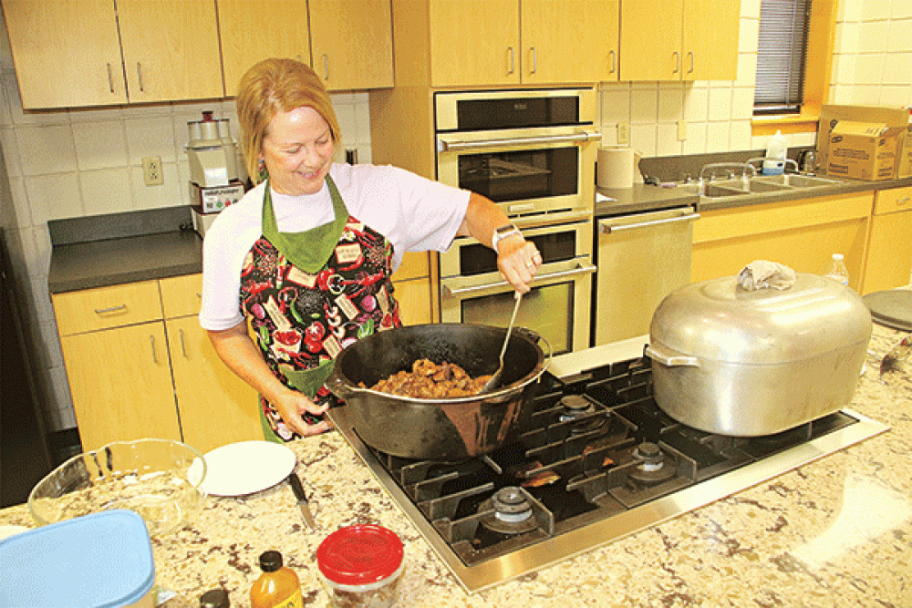 Michelle Brown browns the meat for the “CFMA Stew” during a cooking demonstration Thursday at LSUE. The pork stew was prepared for a networking session of the St. Landry Parish Tourism Commission. (Photos by Harlan Kirgan)