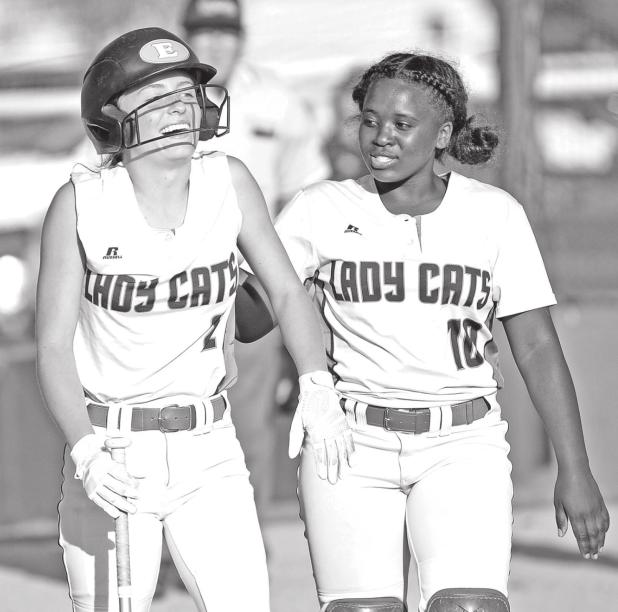 Eunice High’s Sophie Vidrine, left, and McKenzie Guillory celebrate after Vidrine’s home run against Washington-Marion. (Photo by Tom Dodge)