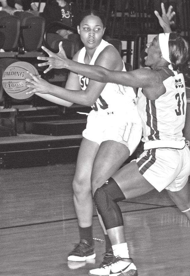 LSUE‘s Alona Washington looks to pass the ball as MGCCC’s Aniya Saddler defends on the play. Washington led the Lady Bengals with 14 points. (Photo by Tom Dodge)