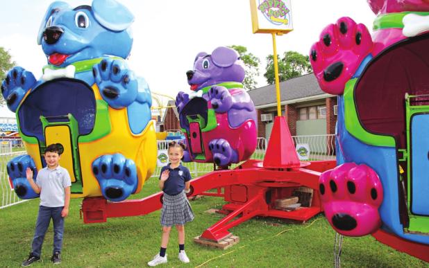 St. Edmund Elementary first graders Charles Patrick Cunningham and Harleigh Credeur are looking forward to this weekend for the St. Edmund Spring Fair. Their teacher is Michelle Newsom. The Puppy Roll is one of the many fair rides on the grounds behind the elementary school. (Photos by Myra Miller)