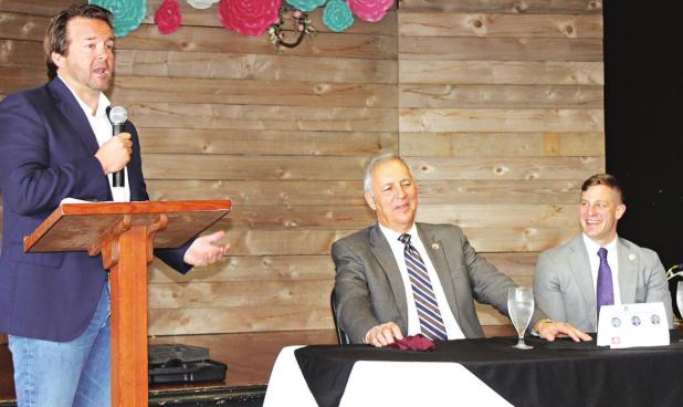 State Rep. Phillip DeVillier, R-Eunice, speaks during Friday morning’s Legislative Breakfast hosted by the Acadia Parish Chamber of Commerce and sponsored by Acadia Parish Farm Bureau. Looking on are Sen. Mark Abraham, R-Lake Charles, center, and Rep. John Stefanski, R-Crowley. (Photo by Steve Bandy/The Crowley Post-Signal)