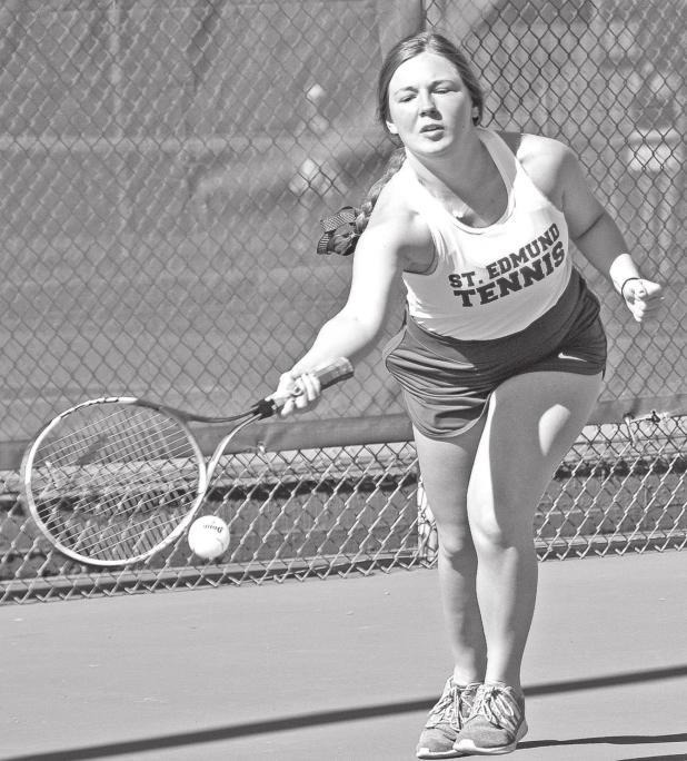 St. Ed’s Ann Marie Dubois returns a serve against Sacred Heart. (Photo by Tom Dodge)