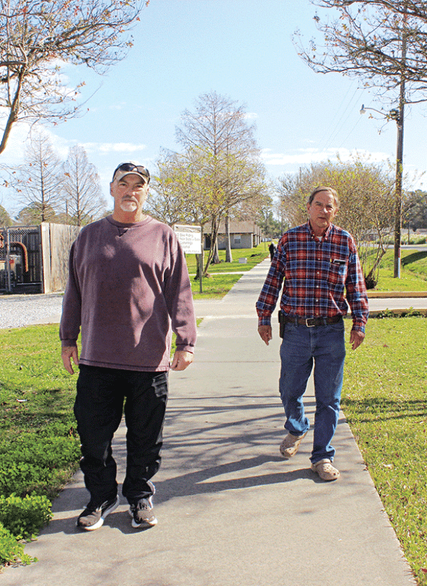 Above, Glynn Credeur, left, and Errol Larriviere, both of Eunice, enjoy the sunny morning Thursday as they took a walk at the Eunice Community Nature Trail. Walking weather will take a turn to the chilly side by Monday when lows begin dipping to below freezing. At right, Bryan Frey, of Eunice,  said he walks daily at the trail. (Photos by Myra Miller)