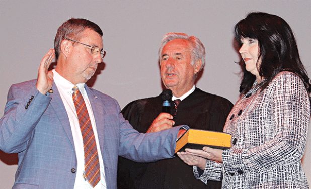 St. Landry Parish President Jessie Bellard, left, recites his oath delivered by Louisiana Associate Supreme Court Judge James Genovese and Bellard’s wife, Melissa, holds a bible. 
