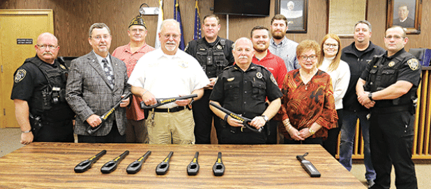 With hand-held scanners are officials and some of the donors who helped pay for the equipment. From left, are Deputy George Cain, Parish President Jesse Bellard, VFW Post Commander Donnie Fontenot, Police Chief Kyle LeBouef, Deputy John Medlin, City Marshal Terry Darbonne, Joseph Tuminaro of State Farm, Trey Ducote of State Farm, Evelyn Stringer of WoodmanLife Chapter 243, Caroline Frey of State Farm, Mayor Scott Fontenot and Chief Deputy Joey Peloquin. (Photo by Harlan Kirgan)
