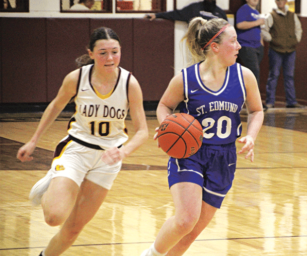 St. Ed’s junior Ava Smith dribbles looking for a teammate to pass to during Friday night’s win against Iota that improved the team’s overall record to 14-3. (Photo by Rhett Manuel)