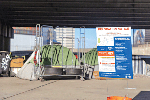 A relocation notice posted in front of a makeshift shelter at the Earhart encampment Monday, Jan. 13, 2025. Those living at the underpass will be transported Wednesday to the Transitional Center. (John Gray/Verite News) 
