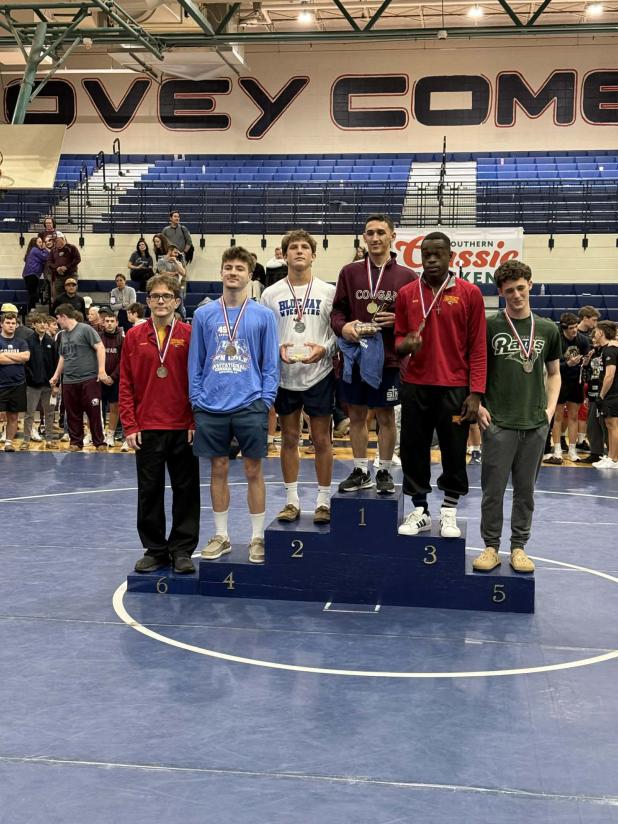 St. Edmund sophomore wrestler Cooper Berzas, third from left, stands holding his trophy among others at the Ken Cole Invitational competition. (Submitted photo)