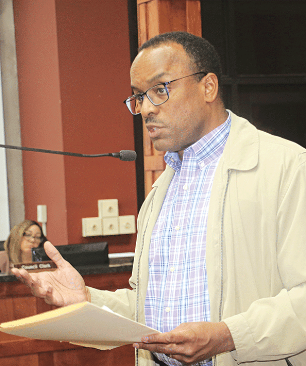 Herman Fuselier, St. Landry Parish Tourist Commission executive director, reviews tourism statistics at the St. Landry Parish Council meeting on Wednesday in Opelousas. (Photo by Harlan Kirgan)