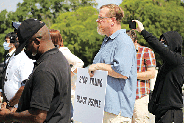 Joe Vanderbrook of Lafayette displays a sign during a rally to support Ronald Greene’s family at the State Capitol on Thursday, May 27, 2021.(Photo by Wes Muller/Louisiana Illuminator) 