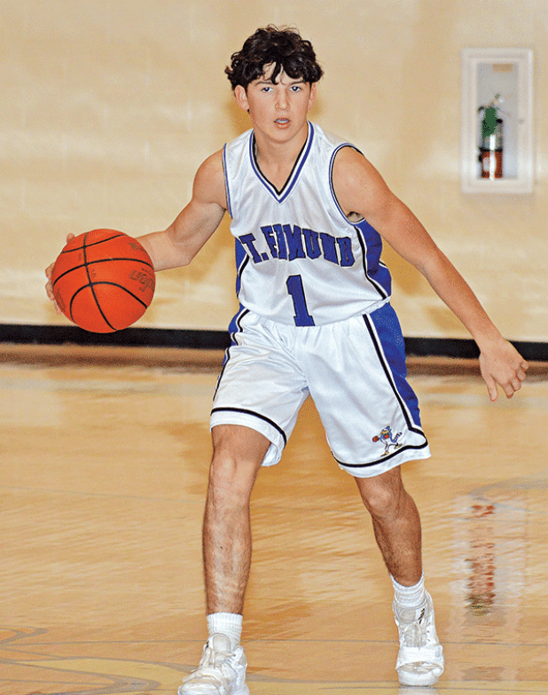 St. Edmund’s Owen Cart brings the ball down the court against Iota. (Photo by Tom Dodge)