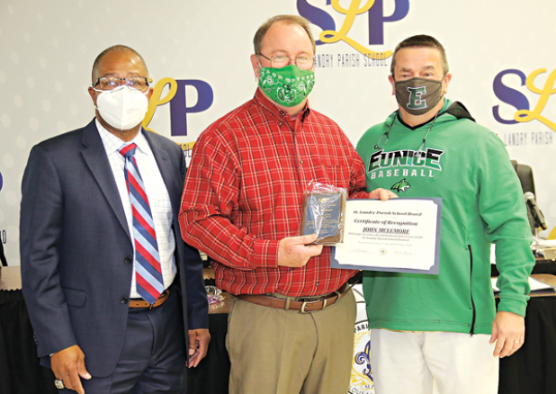 John McLemore, center, was honored on his retirement from Eunice High School and 33 years of service at Thursday’s St. Landry Parish School Board meeting in Opelousas. From left, are Superintendent Patrick Jenkins, McLemore, and Eunice High Principal Mitch Fontenot. (Photos by Harlan Kirgan)