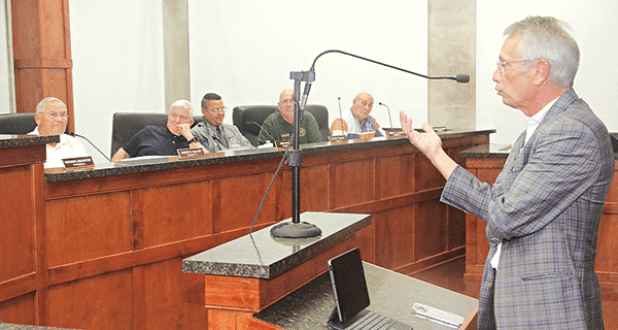 Eric Lafleur, right, a bond attorney, speaks to the St. Landry Parish Council on Wednesday. Council members seated from left are Harold Taylor Ken Marks, Dexter Brown, Timmy Lejeune and Ernest Blanchard. (Photo by Harlan Kirgan)