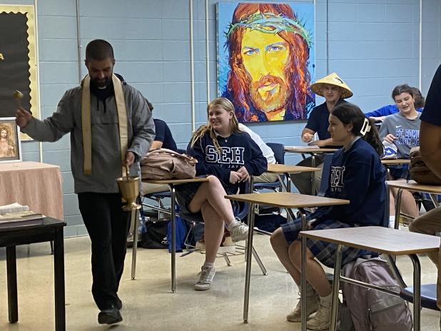 The Rev. Nick Ware blesses each classroom at St. Edmund
