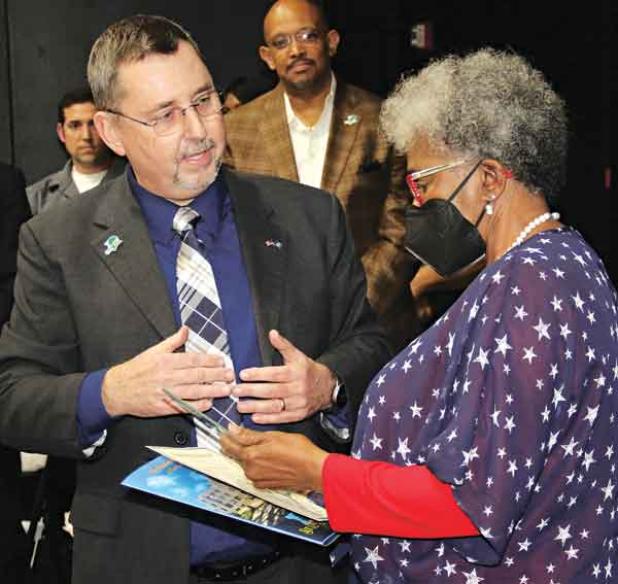 St. Landry Parish President Jessie Bellard, left, presents Pat Mason-Guillory with the President’s Award during the State of the Parish ceremony held Thursday in the Delta Grand Theater in Opelousas. The event was the first for the award and the address. In the rear, center, is Richard Lewis, who serve as master of ceremonies. Lewis is the parish’s code enforcement officer. (Photos by Harlan Kirgan)