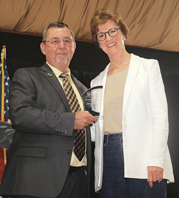 Lisa Miller, right, St. Landry Parish Health Unit director, was presented with a Retirement Award at the State of hte Parish event held Monday at Eunice High School. Presenting the award is Parish President Jessie Bellard.