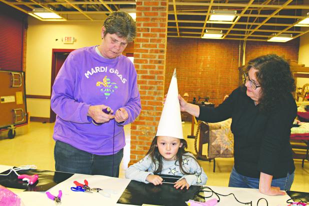 The Mardi Gras events at the Prairie Acadian Cultural Center in Eunice on Saturday included Children’s Capuchon Making. Children had the opportunity to craft their own Mardi Gras capuchon. From left are Laura Launey of Ville Platte, Aleda Launey, 4, of Eunice, and Melissa Walker, of Eunice.