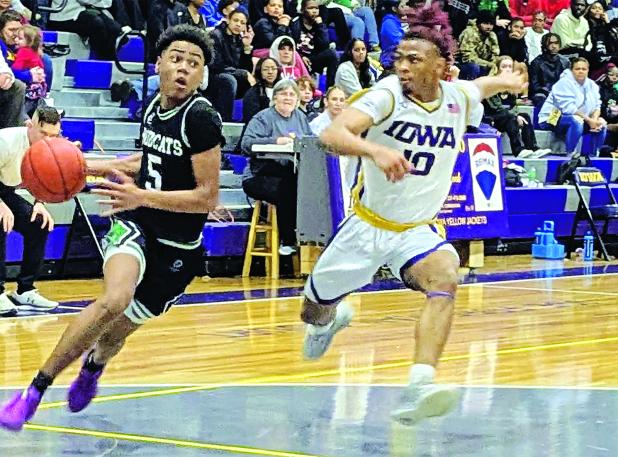 Eunice High sophomore guard Devonte Johnson attempts to drive to the basket in last Friday night’s 70-61 loss to Iowa I. District 3-4A play. Johnson ended the game with five points.  (Photo by Rhett Manuel)