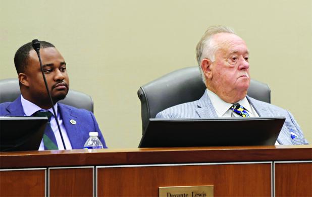 Louisiana Public Service Commissioner Davante Lewis, left, sits next to Chairman Mike Francis during the Feb. 19 PSC meeting. (Photo credit: Wes Muller/Louisiana Illuminator) 