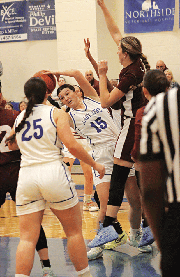 St. Edmund’s Kennedy Dubroc twists to avoid a Covenant Christian Lady Lions player. (Photo by Amy Myers)