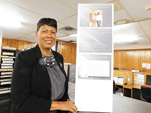 St. Landry Parish Clerk of Court employee Debra Sostand displays one of the several exhibits. (Submitted photo) 