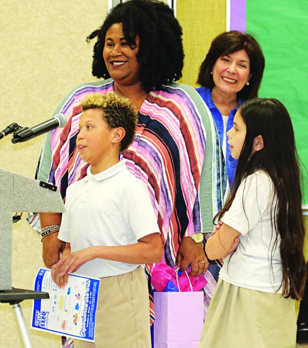 Central MIddle School Leader In Me students, from  left, Jayden Archangel and Zoey Fisher introduce themselves to the St. Landry Parish School Board at Thursday’s meeting. With them, from left are Principal Shelsy Williams and Early Childhood Education Director June Inhern. Each month Leader in Me students help with award presentations at the  School Board meeting. (Photo by Harlan Kirgan)