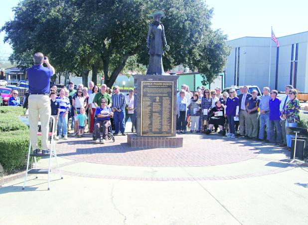 Eunice Rotary Club member Dwight Jodon takes a group photo at the Centennial Wall dedication on Friday. (Photo by Harlan Kirgan)