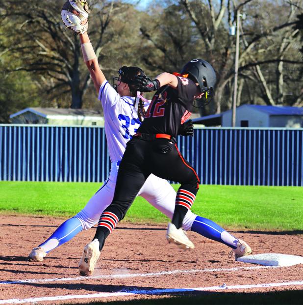 St. Edmund’s Kennedy Dubroc stretches to make an out at first against Pine Prairie. (Photo by Amy Myers) 