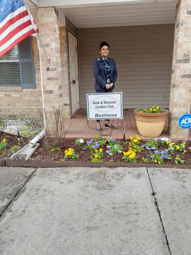 Angelia Guillory accepts the Bulb's Business Garden of the Month marker