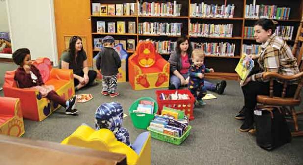 Mallory Moser, a volunteer, read a story book, “Goodnight Train,” by June Sobel, to children Wednesday morning during the library’s Story Time. Children of all ages are welcome to attend Story Time at 10 a.m. on Wednesdays in the upstairs children’s section at the library. The kids also enjoyed creating a craft and had a snack. (Photo by Myra Miller)