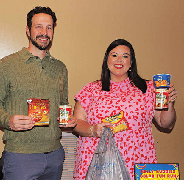 Belly Buddies, a program to fight childhood hunger, has been in existence nearly 10 years, and is hoping to expand. Chad Andrepont, the board president; and Katie Richard, the founder and executive director of the non profit program are with food items. Suggested food items are ones that are easy to open and prepare by a child. (Photo by Myra Miller)