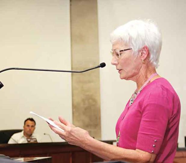 Ruth Andrus, of the United Daughters of the Confederacy, reads a statement from her organization about Confederate memorials at the St. Landry Parish Council meeting on Wednesday in Opelousas. At left is Council member Coby Clavier. (Photo by Harlan Kirgan)