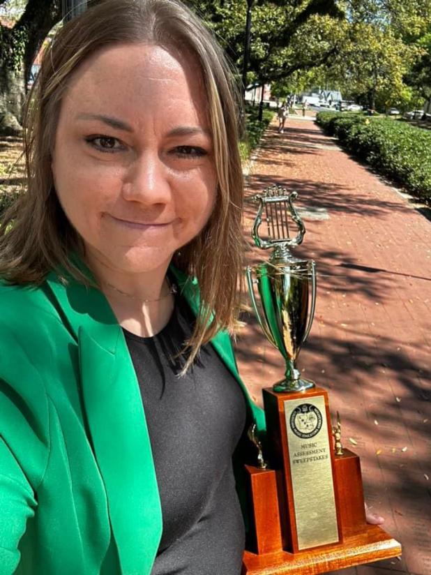 Emily Young, band director at Central Middle and Eunice Jr. High, and her band students recently participated in a district music competition. They came home with a trophy and superior top ratings. (Submitted photos)