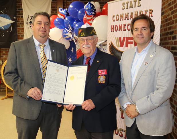 State Rep. Phillip DeVillier, right, presented an expression of condolences to the family of former Eunice Police Chief Gary “Goose” Fontenot to the chief’s son, Mayor Scott Fontenot, left, during VFW State Commander Don Reber’s State Commander Homecoming on April 1. The statement gave history of the former chief’s service that included service in the Army during the Vietnam War at the age of 17. The chief was elected to three terms. Chief Fontenot also served as commander of VFW Post 8971. (Photo by Harlan