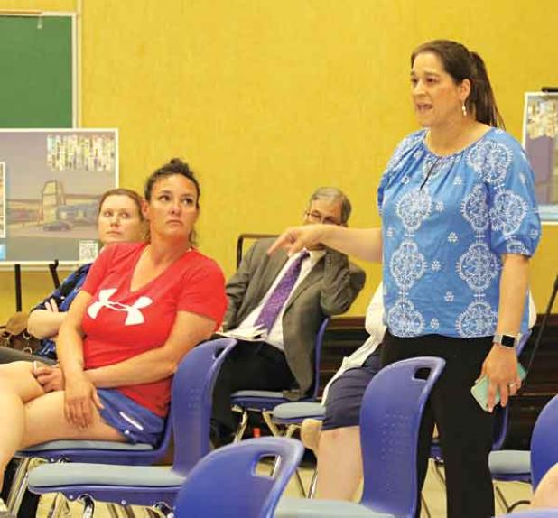 Kristin Bullard, standing at right, a Leonviille Elementary School teacher, at Tuesday’s St. Landry Parish School Board committee meeting. 