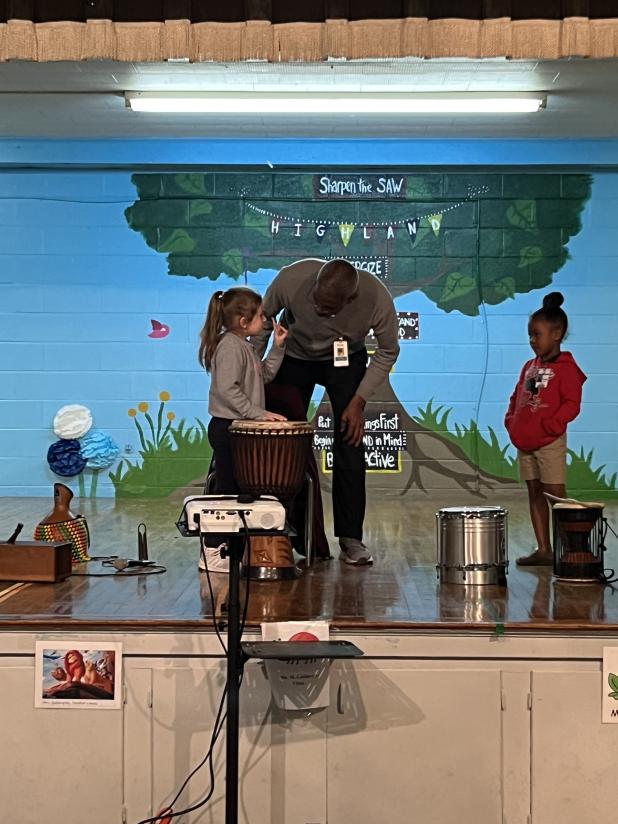 Herb Green from Acadiana Center for the Arts visited Highland Early Learning Center. He played different unique and authentic drums from around the world for the students. From left, are Grace Vidrine, Green, and Italy Senegal. (Submitted photo)