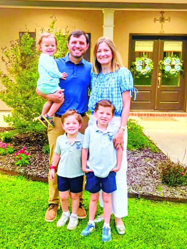 St. Edmund new head football coach Jacob Aguillard, his wife and his three sons.