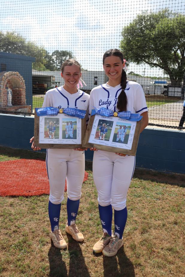 St. Edmund celebrated their seniors softball ladies Monday and gifted them with picture collages, letters from teammates and baskets of goodies. From left are Caroline Lavergne and Aubrie LeJeune. (Photo by Amy Myers)