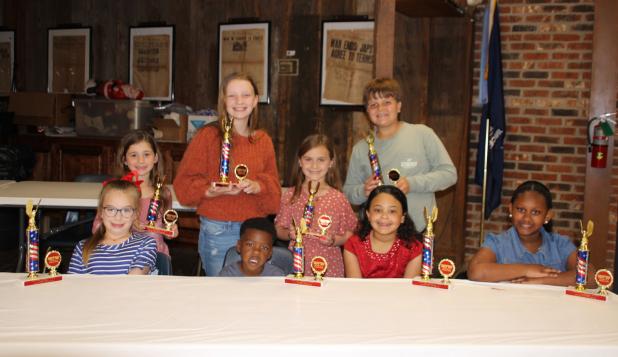 The VFW Post 8971 and Auxiliary honored students who placed in their annual Americanism essays contest. Students were awarded with cash prizes, plaques and trophies during a banquet held Wednesday evening. Seated, from left, are Allison Clark, Khaysten Frank, Madison Guillory,  and Ava Bushnell. Standing, from left, are JoAnn Leger, Olivia Smith, Kennedy LaFleur and Cooper DeVillier. Not pictured are Addaleigh Collins, and Alice Bellard. (Photos by Myra Miller)
