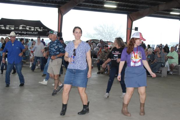 A group of line dancers danced to live music by Jamie Bergeron & The Kickin’ Cajuns Saturday afternoon at the Crawfish Etouffee Cook-Off held under the pavilion at the Northwest Community Center. The bands that entertained the crowds included Seth Spell & Cajun Strong,  and Geno Delafose & French Rockin’ Boogie. Directly in the front from left are Laura Pitre and Bonnie P. Kyzar. (Photos by Myra Miller)