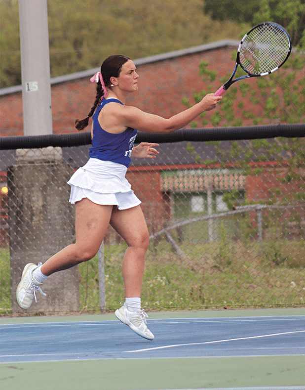 Millie Miller is returning serves. With her partner Laura Kate Miller, they won both their matches. One was against Hathaway, 6-0 and one against Lacassine, 6-1.