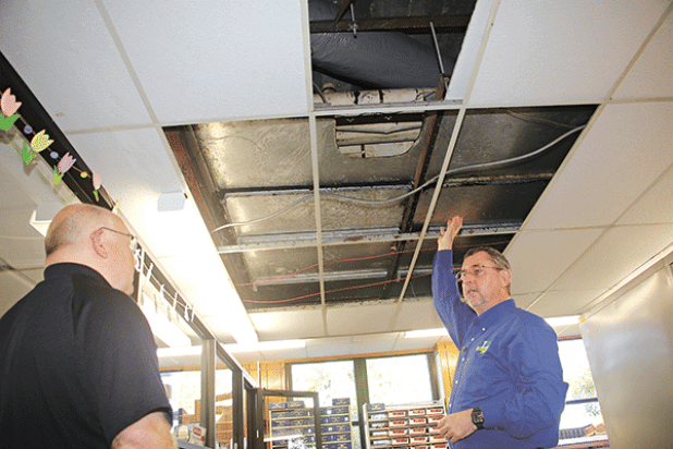 St. Landry Parish President Jessie Bellard, right, shows where smelly water flooded Room 206 in the St. Landry Parish Courthouse on Monday. With Bellard is Van Reed, director of emergency preparedness and a parish administrator.