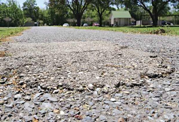 The asphalt track at the walking park is to be widened and repaved with concrete using a $400,000 state grant. (Photo by Harlan Kirgan)