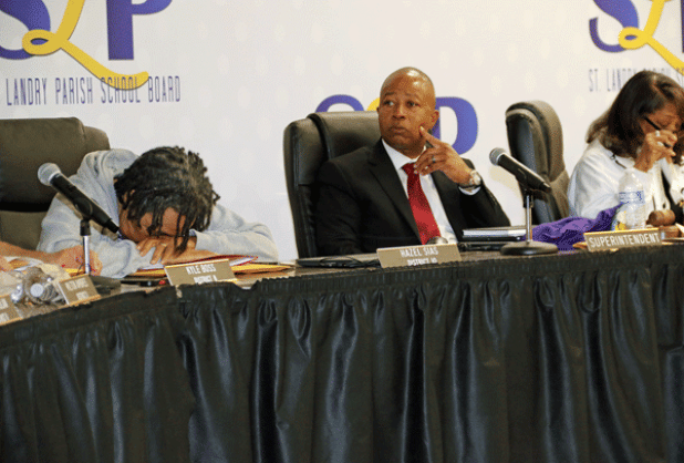 After about two hours in closed session and another hour of meeting left, St. Landry Parish School Board member Hazel Sias briefly put her head down. The Board decided Thursday night to oust Superintendent Patrick Jenkins, center, in a buyout. At right is Board President Joyce Haynes. Jenkins will be paid through June 30 when his contract expires. (Photo by Harlan Kirgan)