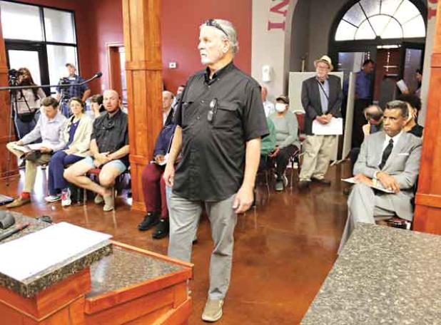 Opelousas attorney Robert Voitier Jr. opposed the removal of a Confederate monument on the St. Landry Parish courthouse grounds during a Parish Council meeting Wednesday in Opelousas. Seated at right is former Parish District Attorney Charles Cravins who argued for the monument’s removal. Standing in the rear is Don Leger, of Opelousas, who also supported removal of the monument. The Parish Council voted to remove to monument. (Photo by Harlan Kirgan)