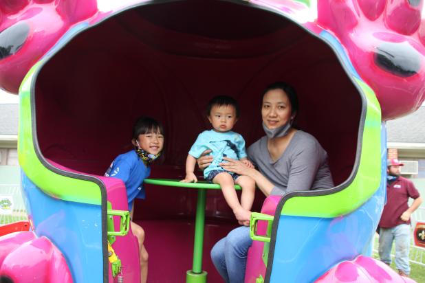 A family on the Puppy Roll fair ride at St. Edmund.