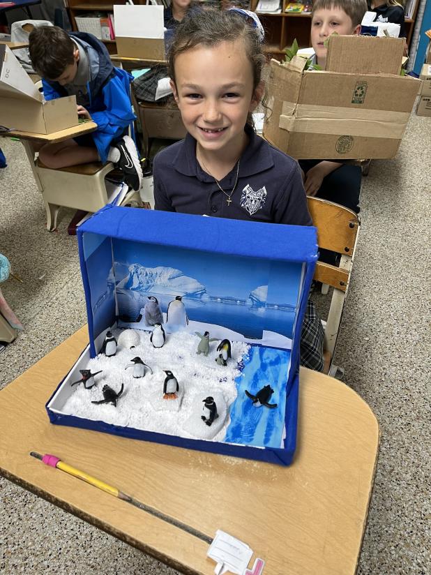 Ayda Fuselier, a second grade student at St. Edmund Elementary, shows off her exhibit. 