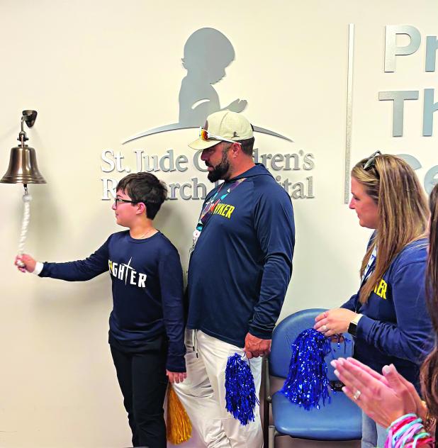 Rkyer Navarre rang the St. Jude bell on his last day of radiation  with his parents Dylan and Elaina Navarre. (Submitted photo)