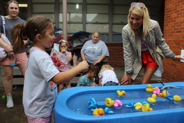 Riley Garcille at duck pond at St. Ed Spring Fair