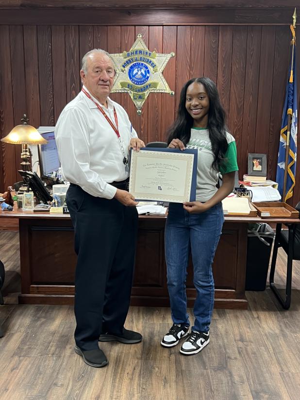 St. Landry Parish Sheriff Bobby Guidroz presents the Louiisiana Sheriff’s Scholarship to Eunice High senior Fajah Guillory. (Submitted photo)